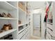 A well-organized walk-in closet offers ample storage with custom shelving, drawers, and a full-length mirror at 523 Coaxum Rd, Mount Pleasant, SC 29464