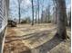 A backyard with scattered pine straw, mature trees, and a wooden deck at 532 Finlay Ln, Cottageville, SC 29435