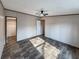 A spacious bedroom includes hardwood floors, neutral paint, fan, and a closet for storage at 532 Finlay Ln, Cottageville, SC 29435