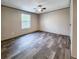 A bright bedroom has hardwood floors and a large window to provide outside light at 532 Finlay Ln, Cottageville, SC 29435