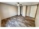 A bedroom features hardwood floors, neutral colored walls, and a closet for storage at 532 Finlay Ln, Cottageville, SC 29435