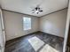 Bright bedroom featuring wood-look floors, ceiling fan, and window offering peaceful views at 532 Finlay Ln, Cottageville, SC 29435