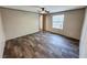 Bright bedroom featuring wood-look floors and a large window overlooking the outdoors at 532 Finlay Ln, Cottageville, SC 29435