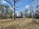 A home in a wooded lot surrounded by mature trees and a large yard at 532 Finlay Ln, Cottageville, SC 29435