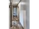 Hallway featuring wood-look floors with doors leading to various rooms, offering privacy at 532 Finlay Ln, Cottageville, SC 29435