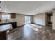 Open-concept living area with wood-look flooring, lots of natural light, and modern lighting fixtures at 532 Finlay Ln, Cottageville, SC 29435