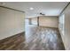 Spacious living room area featuring wood-look flooring, fan, and large windows for natural light at 532 Finlay Ln, Cottageville, SC 29435