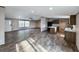 Bright, open living room with wood-look flooring seamlessly connects to kitchen and dining areas at 532 Finlay Ln, Cottageville, SC 29435