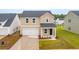 Charming two-story home with neutral siding, attached garage, landscaped front yard, and manicured lawn at 577 Red Monarch Way, Moncks Corner, SC 29461