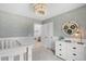 Charming Bedroom with playful wallpaper, a crib, and ample storage space at 579 Red Monarch Way, Moncks Corner, SC 29461