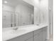 Modern bathroom with double vanity, large mirror, and glass-enclosed shower, showcasing sleek design at 588 Red Monarch Way, Moncks Corner, SC 29461