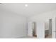 Unfurnished bedroom with neutral carpet, and a bathroom and closet visible through doorways at 588 Red Monarch Way, Moncks Corner, SC 29461