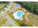 Aerial view of a community with pool, play area and sidewalks at 591 Red Monarch Way, Moncks Corner, SC 29461
