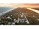 Scenic aerial view showcases the coastline with sandy beaches and a developed town at 702 E Erie Ave, Folly Beach, SC 29439