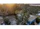 Aerial sunset view of a home nestled among lush trees, showcasing a waterfront property at 702 E Erie Ave, Folly Beach, SC 29439