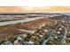 Scenic aerial view highlights houses among trees with the river and marsh in the distance at 702 E Erie Ave, Folly Beach, SC 29439