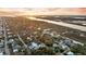 Expansive aerial view features a residential neighborhood surrounded by lush trees and a tranquil river at 702 E Erie Ave, Folly Beach, SC 29439