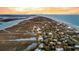 Stunning aerial view of beachfront homes nestled between ocean and marsh, with colorful sunset sky at 702 E Erie Ave, Folly Beach, SC 29439
