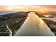 Expansive aerial view captures a river leading to the ocean near a town at sunset at 702 E Erie Ave, Folly Beach, SC 29439
