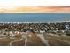 Wide aerial perspective of oceanfront houses with docks and calm beach waters at 702 E Erie Ave, Folly Beach, SC 29439