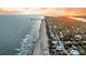 Panoramic aerial view showcasing the coastline, houses, and tranquil beachfront at 702 E Erie Ave, Folly Beach, SC 29439