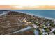 Overhead shot of coastal homes shaded by lush trees, situated along the serene beachfront at 702 E Erie Ave, Folly Beach, SC 29439