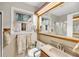 Bathroom featuring a sink, toilet, vanity and large mirror at 702 E Erie Ave, Folly Beach, SC 29439