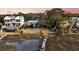 Charming exterior view of waterfront homes with a partially collapsed wooden dock leading to the marsh at 702 E Erie Ave, Folly Beach, SC 29439