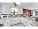 Corner kitchen with stainless steel appliances, and white cabinetry at 702 E Erie Ave, Folly Beach, SC 29439