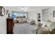 Bright living room with large window and neutral carpeting at 702 E Erie Ave, Folly Beach, SC 29439