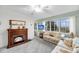 Living room with fireplace and big windows with bright light at 702 E Erie Ave, Folly Beach, SC 29439