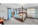 Bedroom with a canopy bed and natural light from sliding doors at 702 E Erie Ave, Folly Beach, SC 29439