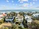 Coastal home with an ocean view surrounded by lush landscaping and neighboring houses in a vibrant community at 707 Ocean Blvd, Isle of Palms, SC 29451