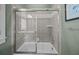 Neutral toned bathroom with a tiled shower, glass doors, and classic fixtures at 707 Ocean Blvd, Isle of Palms, SC 29451