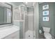 This bathroom showcases a walk-in shower with neutral tiles and a white vanity at 707 Ocean Blvd, Isle of Palms, SC 29451