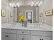 Bathroom showcasing a double vanity with a large mirror and decorative floral arrangement at 707 Ocean Blvd, Isle of Palms, SC 29451