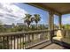 Screened-in porch with wicker furniture overlooking tropical trees and neighborhood street at 707 Ocean Blvd, Isle of Palms, SC 29451