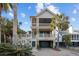 Stunning two-story beach house with multi-level covered decks, lush landscaping, and a brick driveway at 707 Ocean Blvd, Isle of Palms, SC 29451