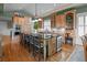 Spacious kitchen features oversized center island with bar seating, built in cabinets, and hardwood floors at 707 Ocean Blvd, Isle of Palms, SC 29451