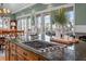Close-up on kitchen island with gas stove and dining room view at 707 Ocean Blvd, Isle of Palms, SC 29451