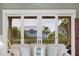 Living room with a view, with sliding glass doors that open to an outside porch and tropical landscape at 707 Ocean Blvd, Isle of Palms, SC 29451