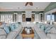 Bright living room with cozy sofas, a ceiling fan, and stylish decor at 707 Ocean Blvd, Isle of Palms, SC 29451