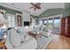 Bright living room features built-in shelving, hardwood floors, and sliding glass doors to balcony at 707 Ocean Blvd, Isle of Palms, SC 29451