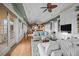 Spacious living room with hardwood floors, built-in shelving, and large windows at 707 Ocean Blvd, Isle of Palms, SC 29451