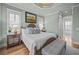 Bright main bedroom features tray ceilings, hardwood floors, and lots of natural light at 707 Ocean Blvd, Isle of Palms, SC 29451