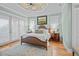 Spacious main bedroom features tray ceilings, hardwood floors, and lots of natural light at 707 Ocean Blvd, Isle of Palms, SC 29451