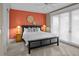 Inviting main bedroom with sleek black bed frame, a ceiling fan, and a stylish accent wall at 707 Ocean Blvd, Isle of Palms, SC 29451