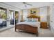 This main bedroom offers a comfortable space with a ceiling fan and an outdoor balcony at 707 Ocean Blvd, Isle of Palms, SC 29451