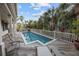 Backyard deck featuring pool with surrounding chaise lounges and palm trees at 707 Ocean Blvd, Isle of Palms, SC 29451