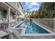 Relaxing rectangular pool surrounded by a wooden deck with palm tree views at 707 Ocean Blvd, Isle of Palms, SC 29451
